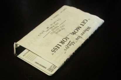 Two cards, rolled and Taped to their receipt.  The folded edges mean the cards have a $0 balance. 